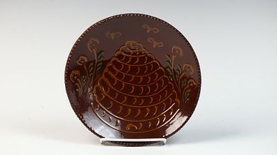 C. Ned Foltz Pottery Redware Beehive Plate, 1986. This redware plate was produced by C. Ned 