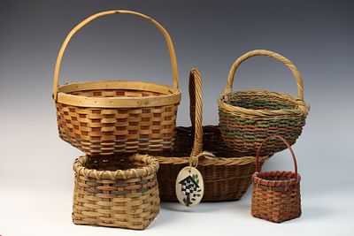 An Assortment of Hand-Woven Baskets. A group of assorted hand-woven baskets featuring various 