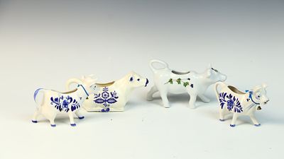 A Collection of Porcelain Cow-Form Creamers including Delft Style and BIA Cordon Bleu. A 