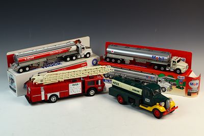 A Group of Four Vintage Exxon, Mobil, and Hess Promotional Toy Trucks. This group of four 
