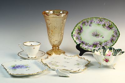 A Collection of Seven Porcelain and Glass Tabletop Items with Floral Motifs and Gilded Accents. A 