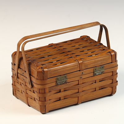 Woven Bamboo Lidded Storage Basket with Dual Handle. A woven bamboo storage basket of 