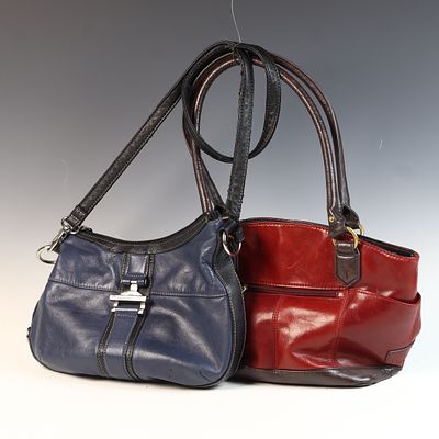 Two Tignanello Handbags in Navy Blue and Oxblood Red. This lot features two handbags 