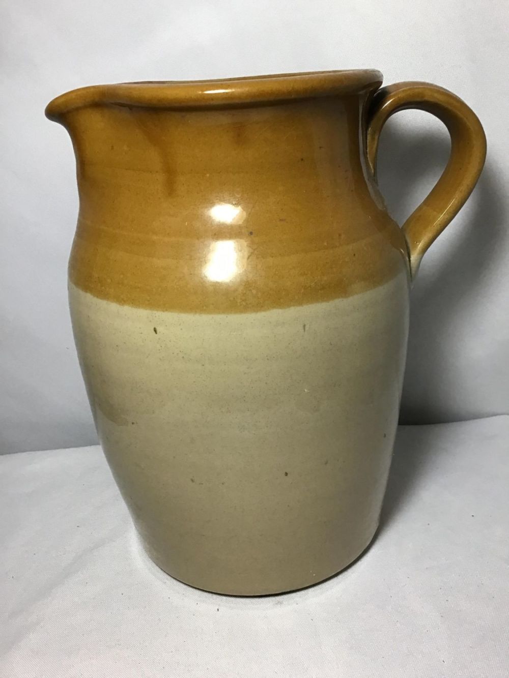 Lot 150: Crock Style Earthtone Pitcher Measures 11 inches tall
