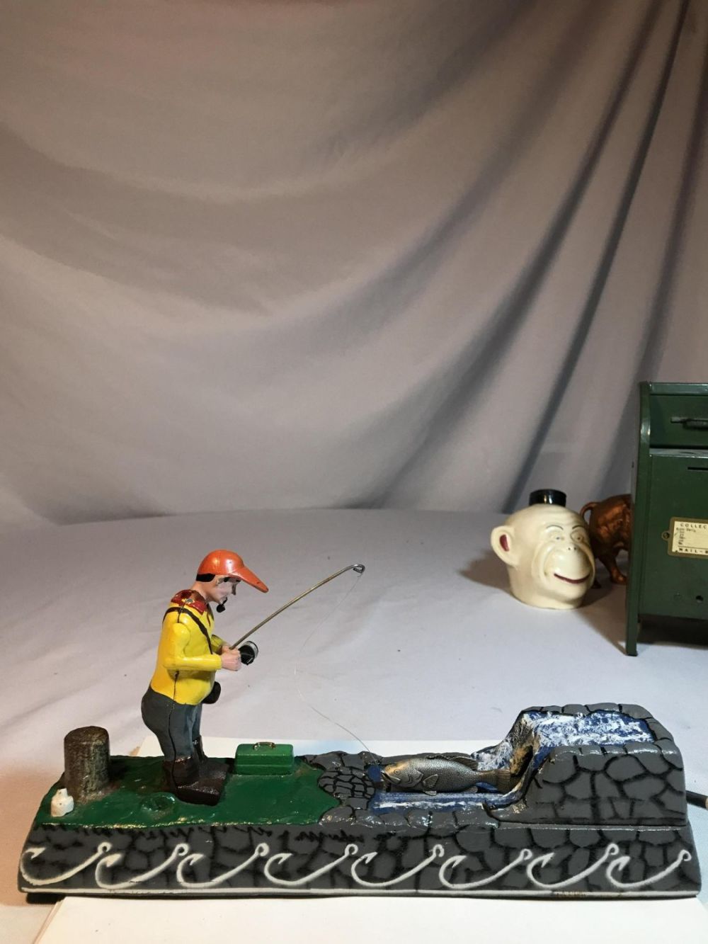 Lot 156: Mechanical Fisherman Bank Cast Iron 12 by 5 1/2
