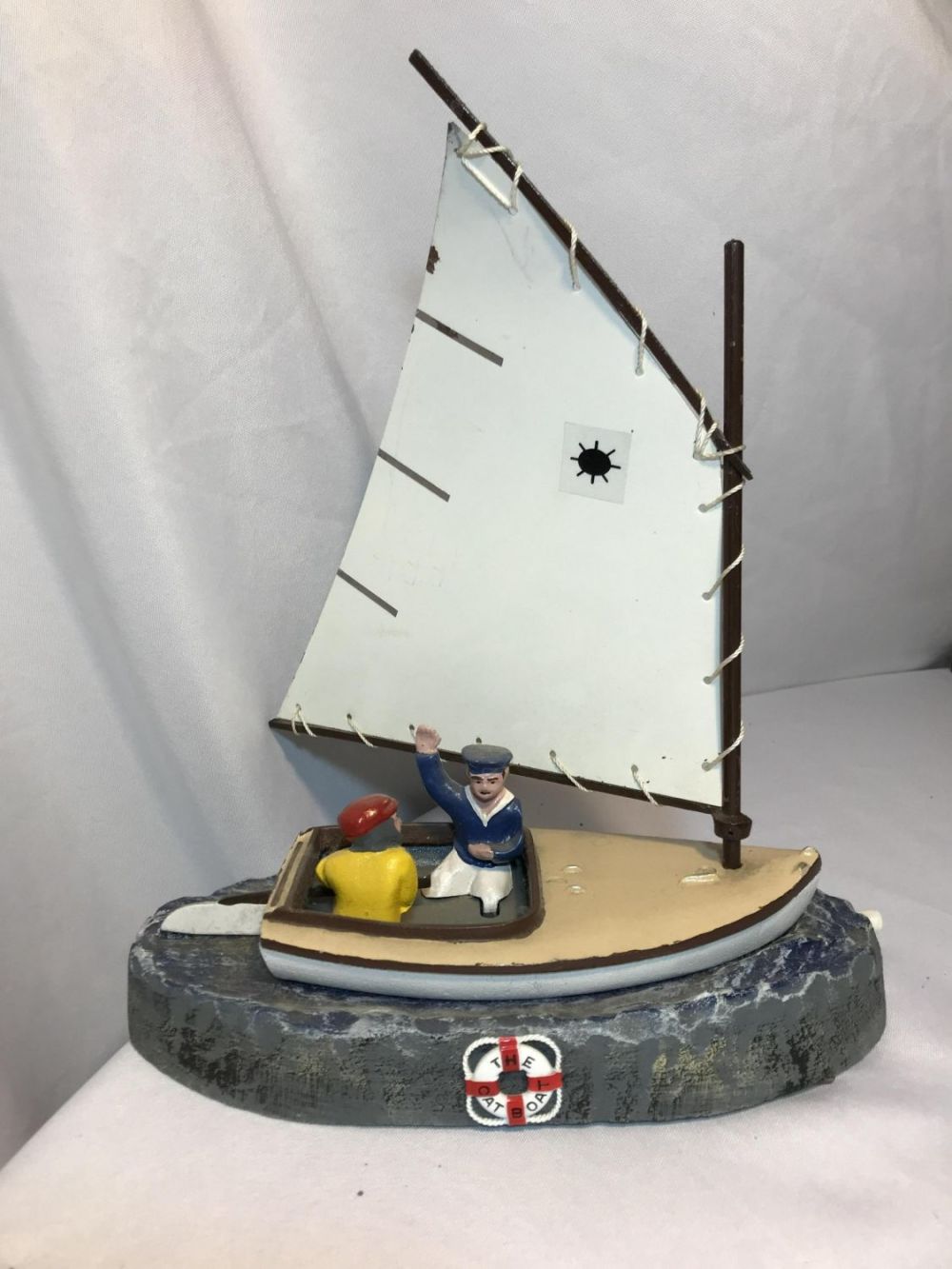 Lot 185: Cast iron, The Cat Boat Coin Bank Measures 14 inches tall by 11 inches wide