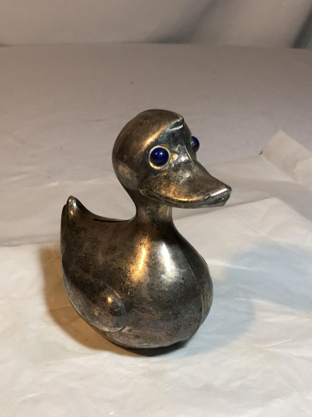Lot 196: Baby blue eyed silver duck bank  Approximately 4 by 4