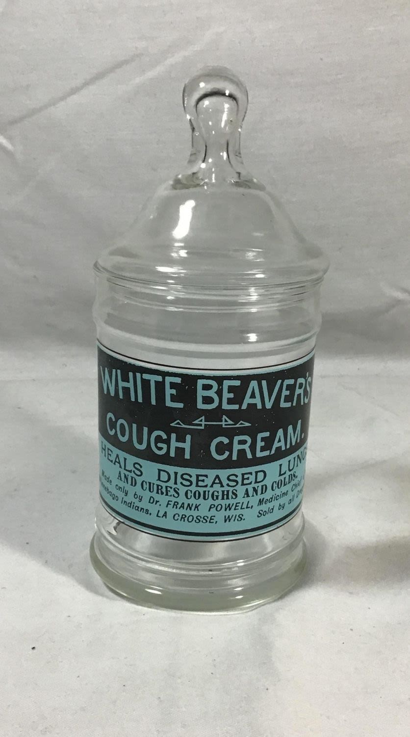 Lot 186: White beavers cough cream jar height 8 1/2 inches .