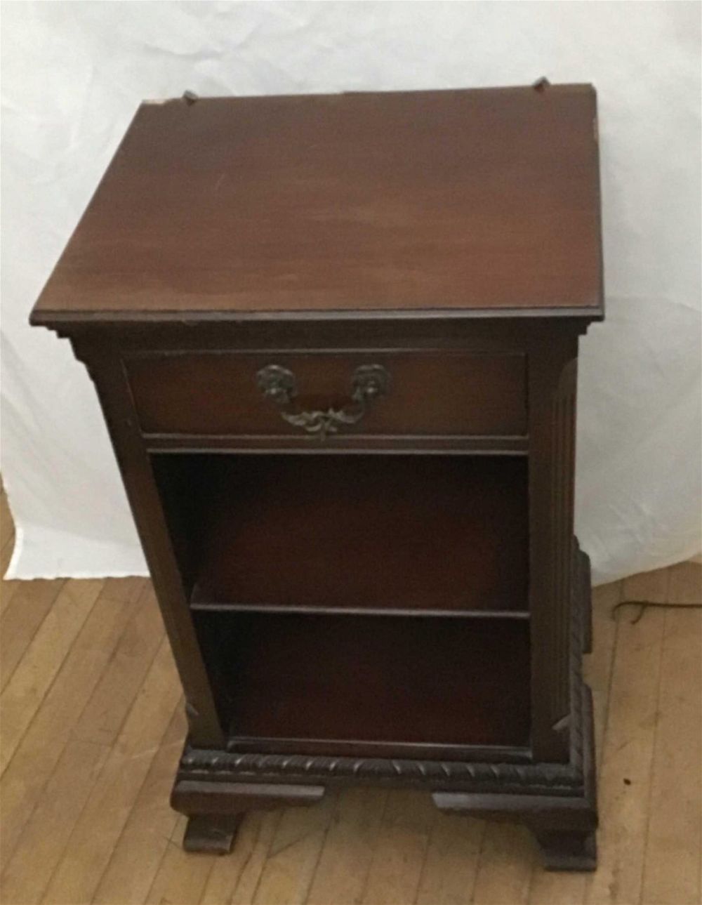 Lot 216: Mahogany End Table with One Shelf Measures 28 inches tall by 18 by 14