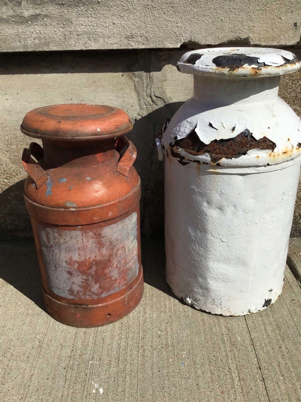 Lot 267: Vintage Milk Cans White measures 25 inches tall orange is 20 inches tall