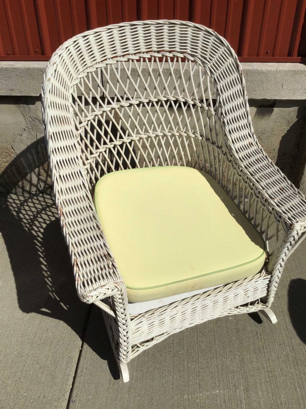Lot 268: Wicker Rocker w/ Cushion Measures 38 inches tall by 30 inches wide