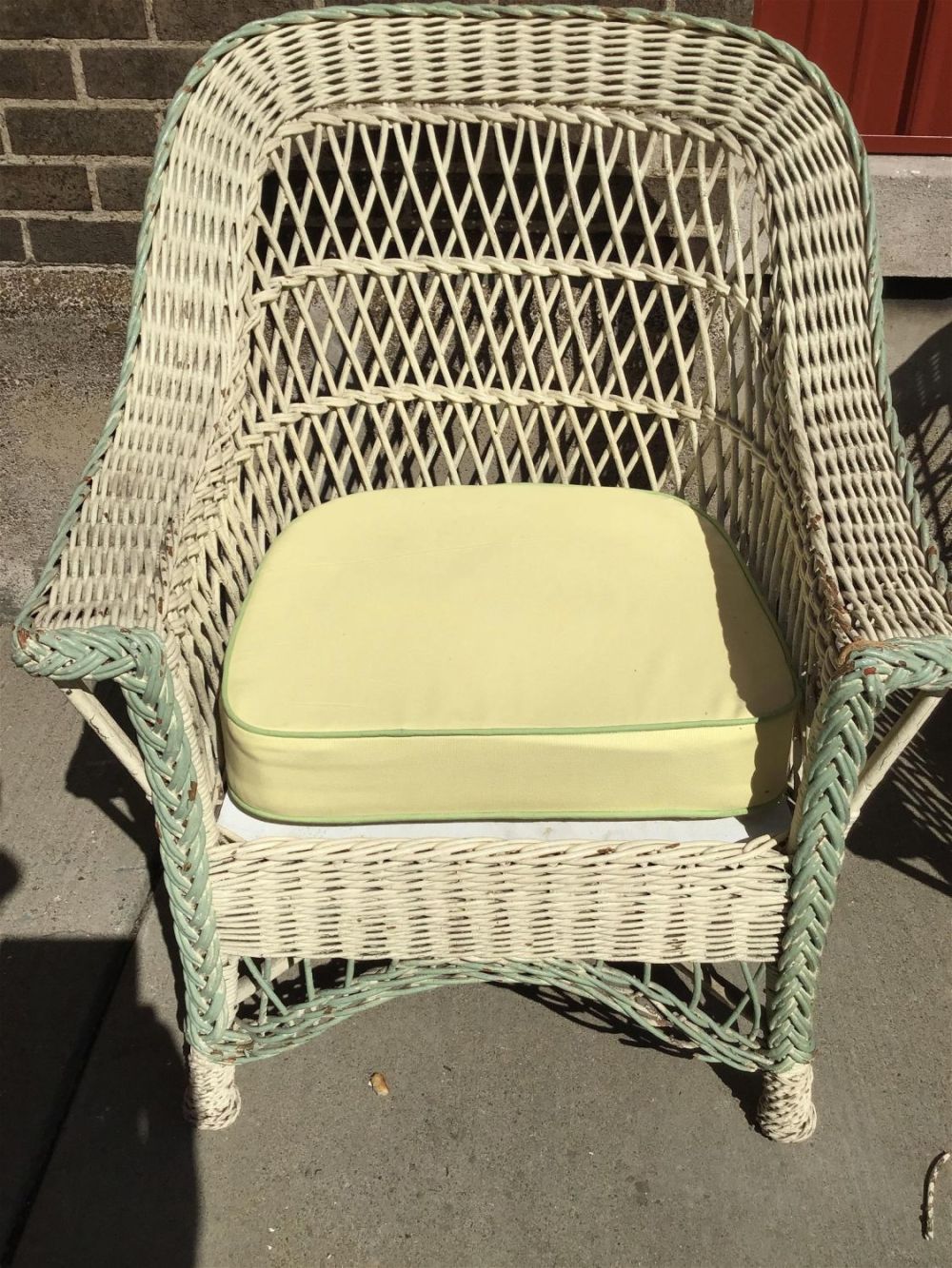 Lot 272: Wicker Chair w/ cushion measures 37 by 29 inches