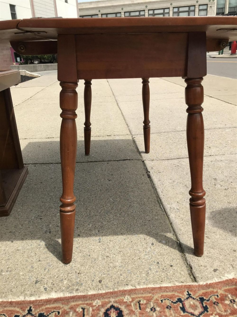 Lot 199: Dropleaf Table Measures 29 inches tall by 50 inches wide by 35 inches