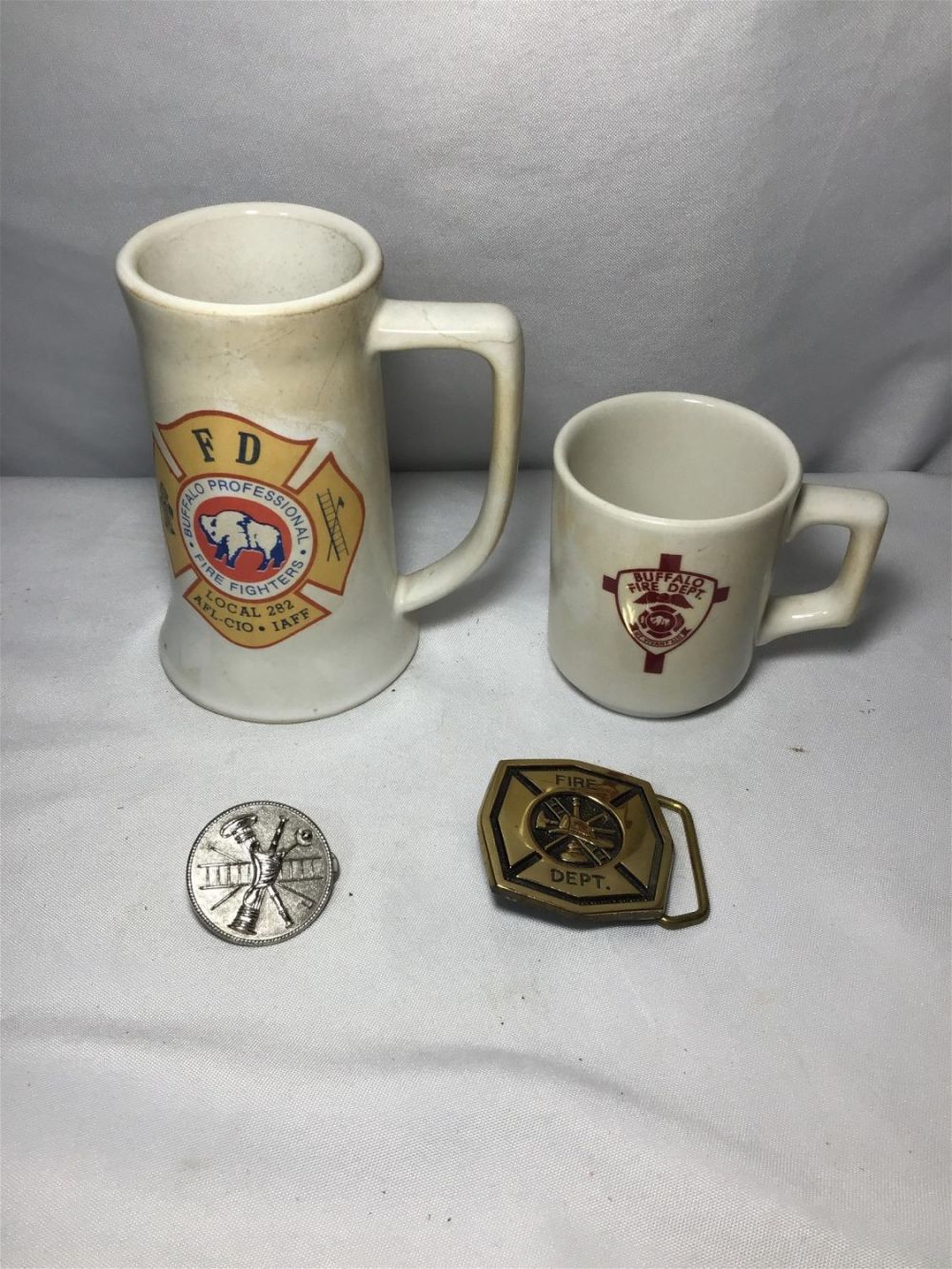 Lot 183: Buffalo Fire Department Collectibles 2 mugs, pin & belt buckle