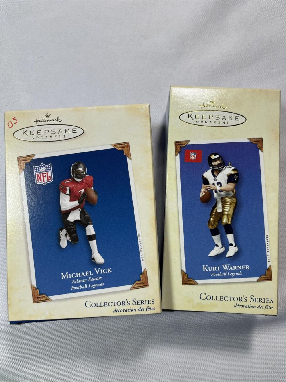 Lot 190: Hallmark Keepsake Ornaments NFL Kurt Warner & Michael Vick in org boxes