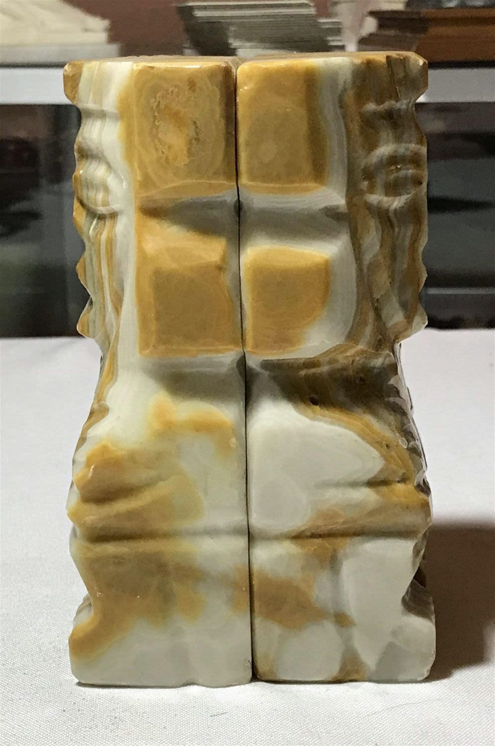 Lot 175: Vintage Decorative Bookends with Faces measures to be five and three-quarter inches tall 2 3/4