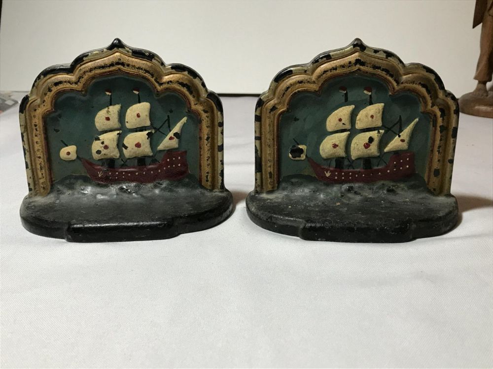 Lot 179: Vintage hand painted iron bookends decorative pieces with pirate ships on the front. Measures to be