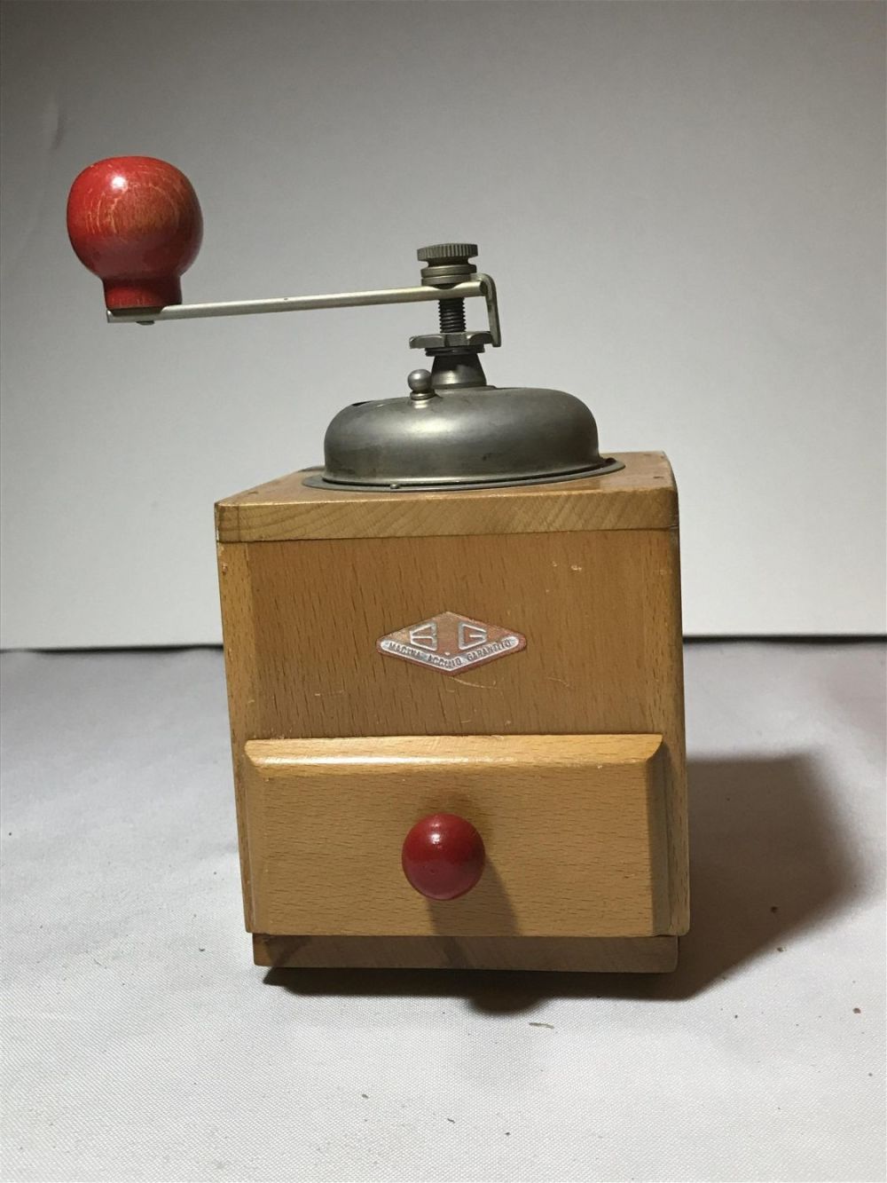 Lot 187: Primitive coffee grinder. Measures to be approximately 4 inches across 8 inches tall and 4 inches