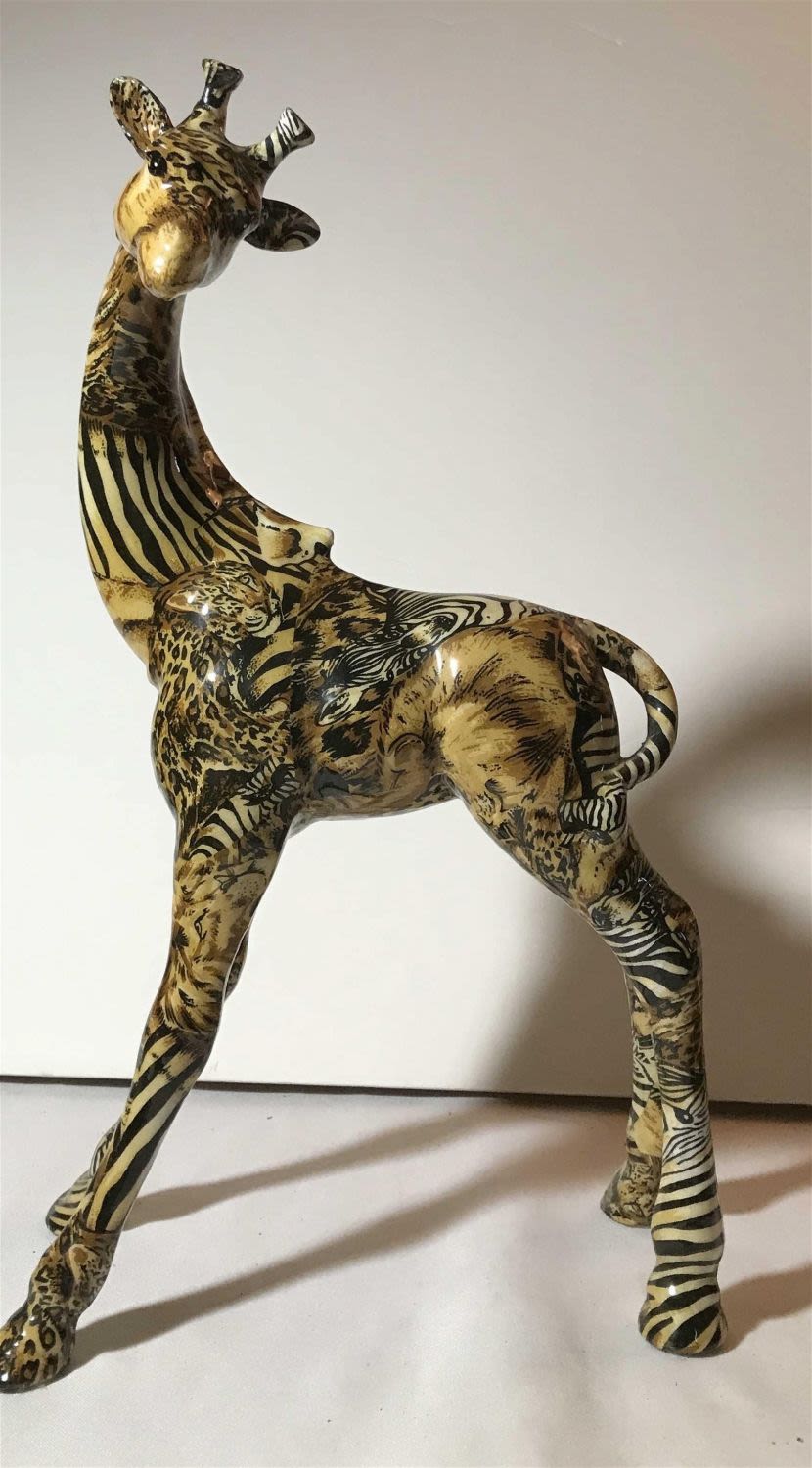 Lot 189: Decorative giraffe figurine with painted figures on the surface of the draft this piece measures to