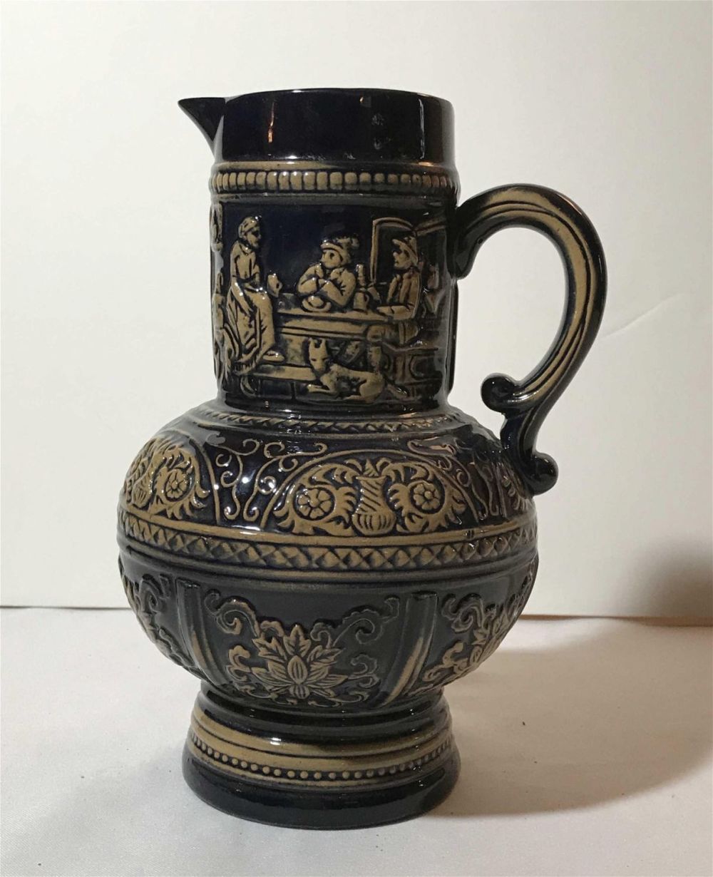 Lot 199: Vintage Salt Glazed Pitcher Measures tobe inches tall and has a diameter of 3 inches at the top and