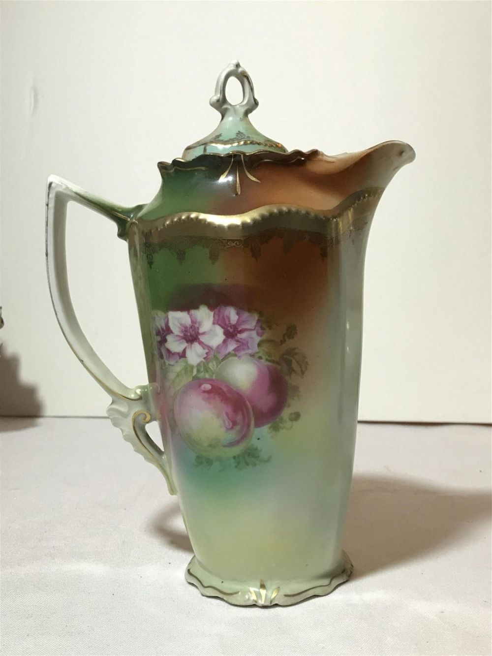 Lot 215: Vintage Hand Painted Chocolate Pitcher Measures approximately 9 1/2 inches tall with a base diameter