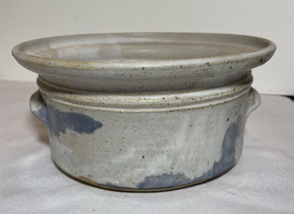 Lot 153: Early stoneware pottery bowl with handles and pattern free glazing. 8 1/4 inches across and depth of