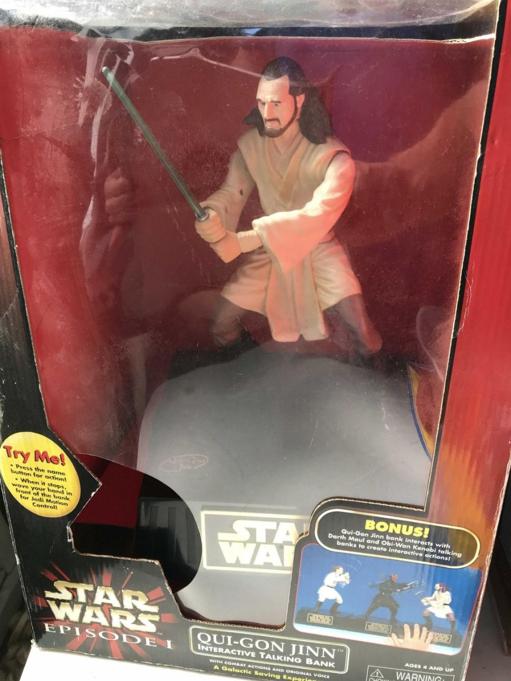 Lot 211: Star Wars Qui-Gon Jinn Talking Bank In original package  Packaging measures 16x10x11.5 inches