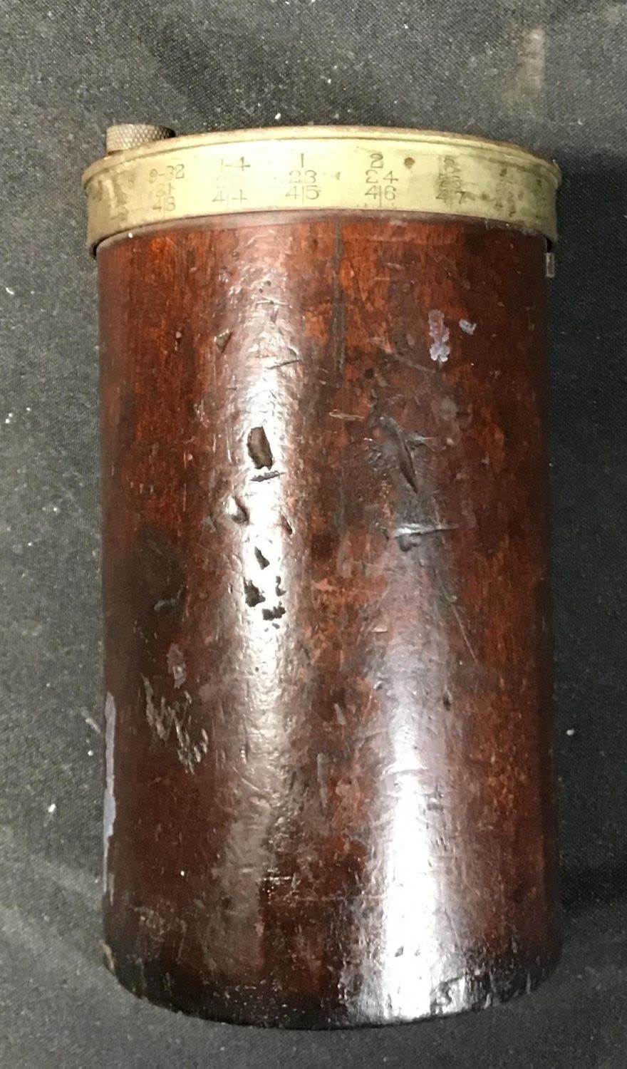 Lot 190: Nickel on brass with wood body drill bit holder