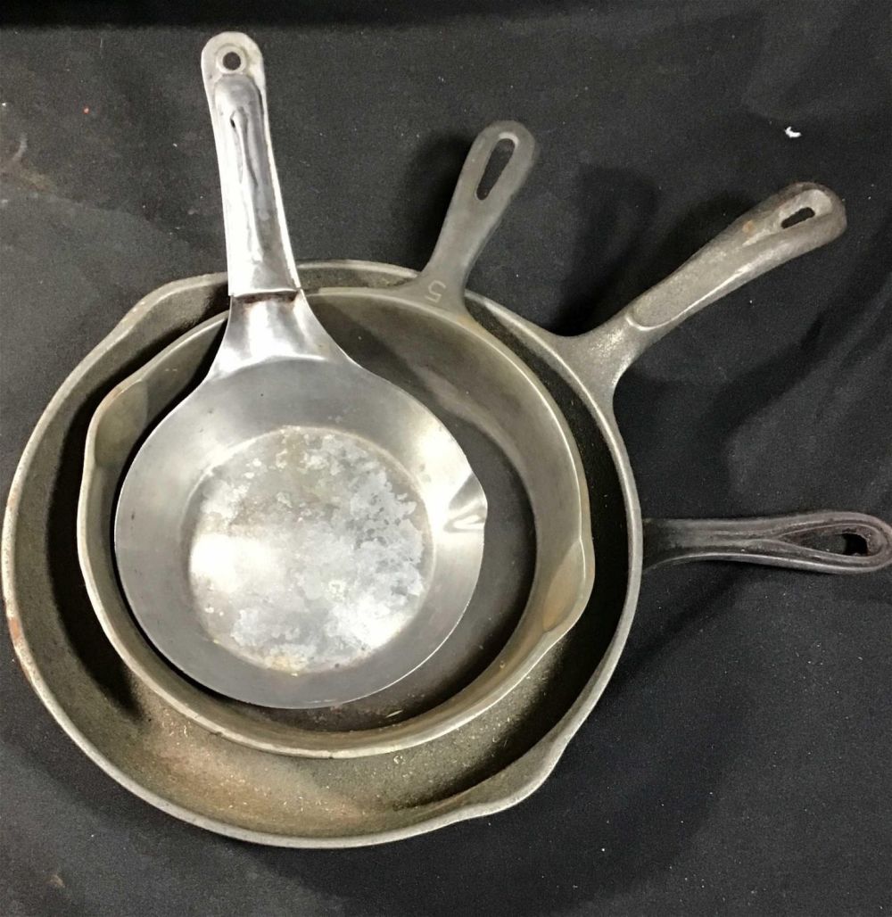 Lot 201: Three cast-iron one steel pan set