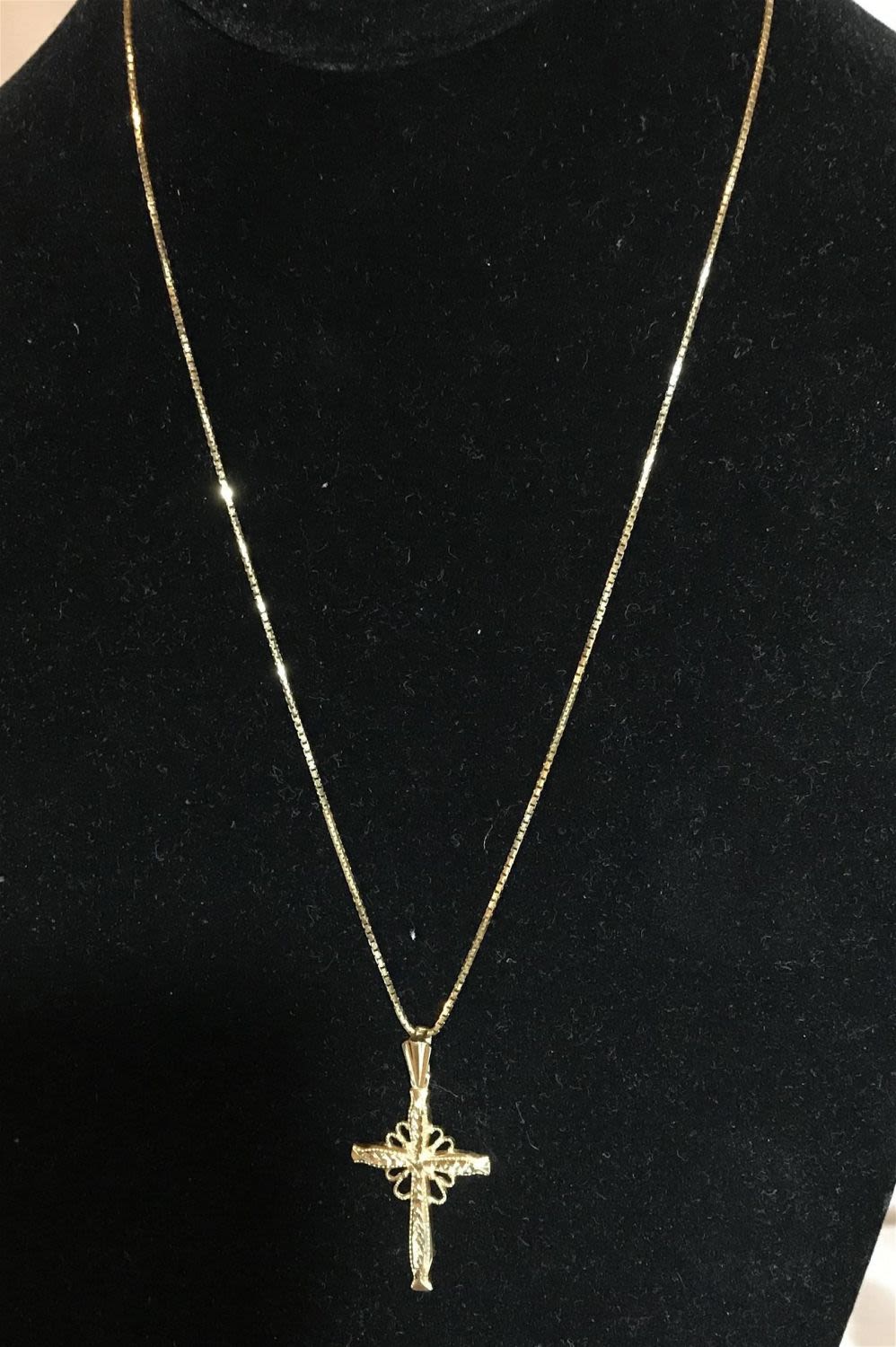 Lot 251: 14 karat gold laser cut cross and 14 karat gold