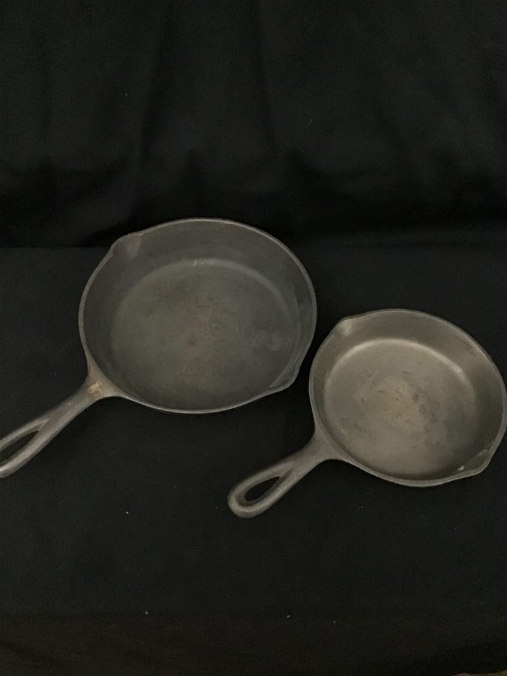 Lot 240: Two cast iron pans, size 5, and three