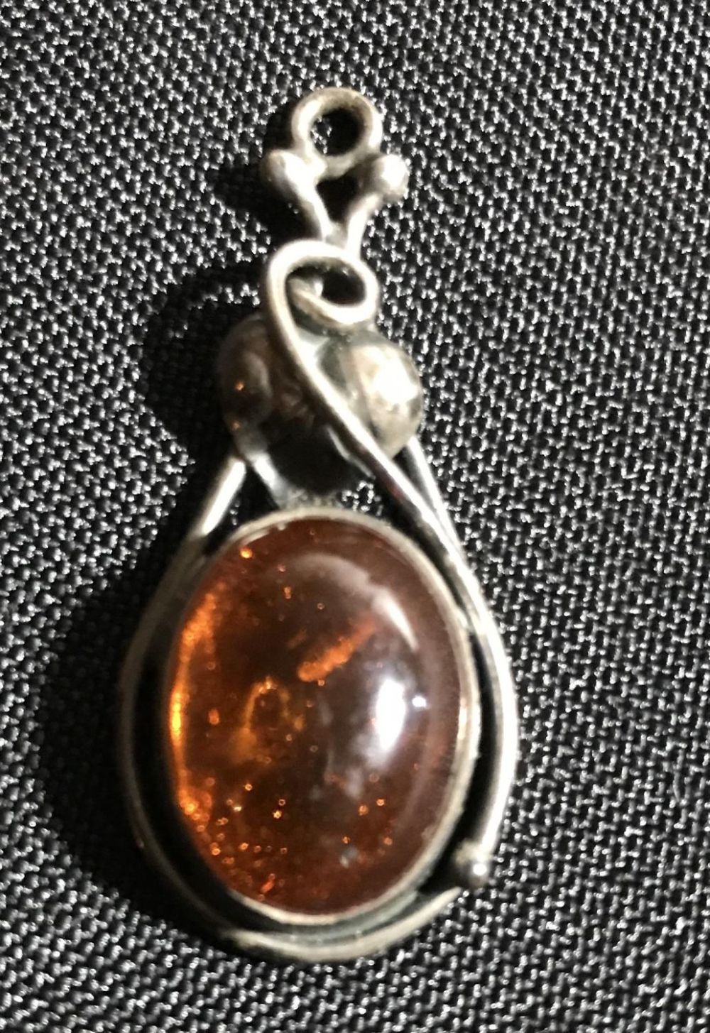 Lot 222: Amber and Sterling Pendant .