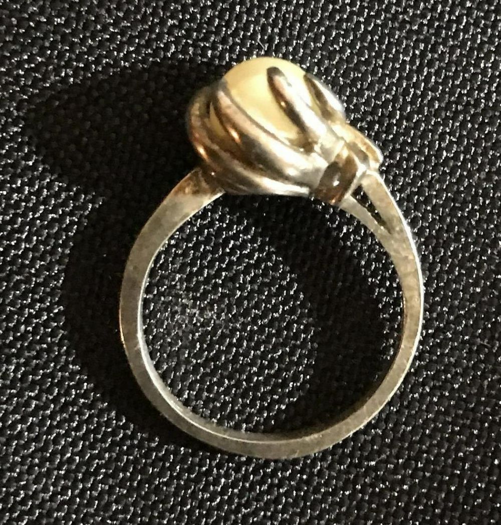 Lot 223: Pearl and Sterling ring size 4 .