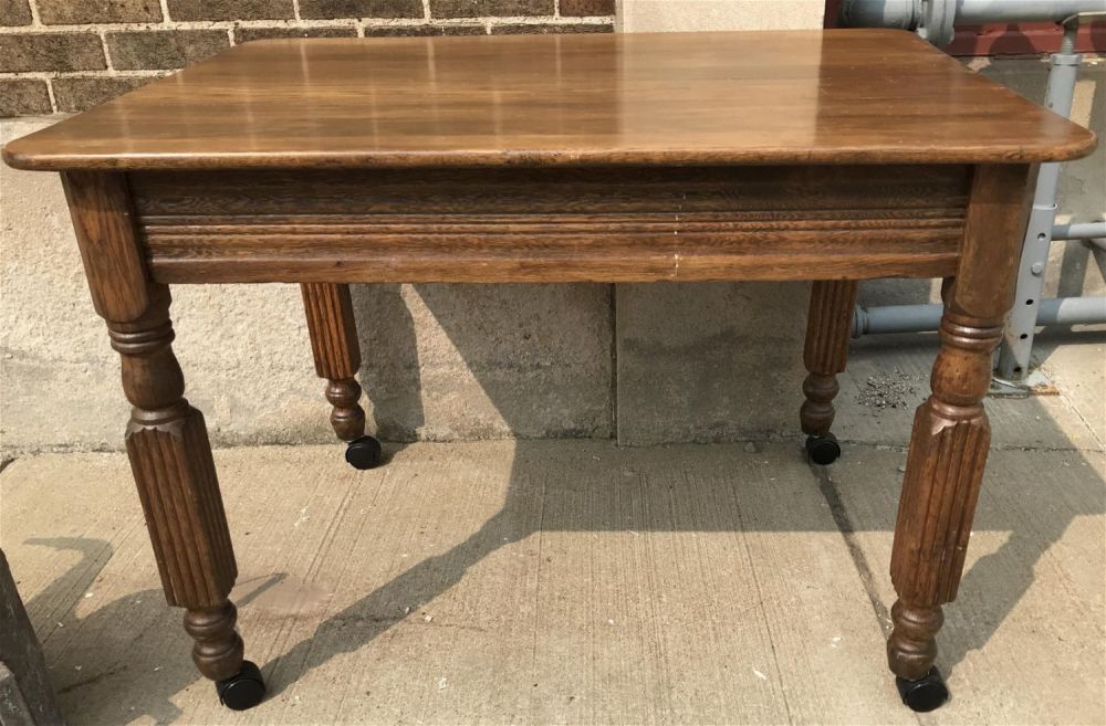 Lot 311: 1950's Solid Wood Kitchen Table on Casters Measures 31.5 by 42 inches wide by 29 inches tall