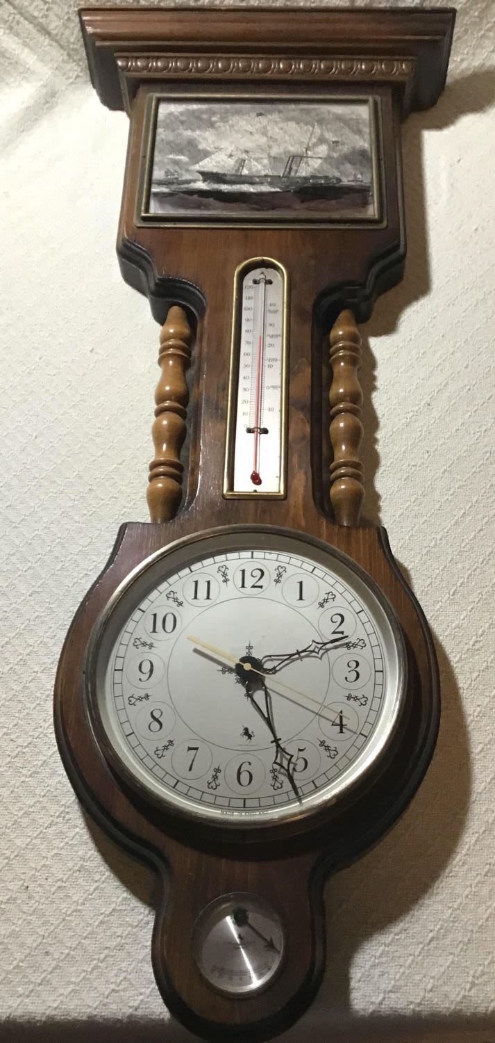 Lot 248: Wooden Wall Hanging Nautical Theme Clock with thermometer and barometer measures 34 1/2 x 10 1/2 top