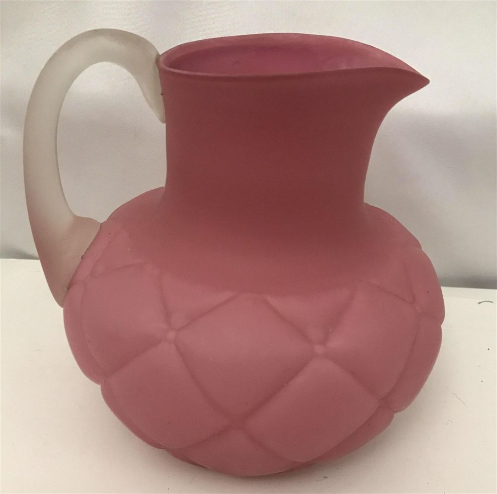 Lot 278: Silk Glass Pitcher, Pink in Color Measures 7 1/2 inches high by 7 1/2 inches wide