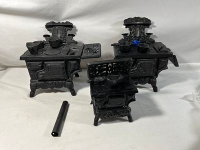 Vintage Mini Queen Cast Iron Stoves w/ parts. 3 cast iron stoves with misc parts.