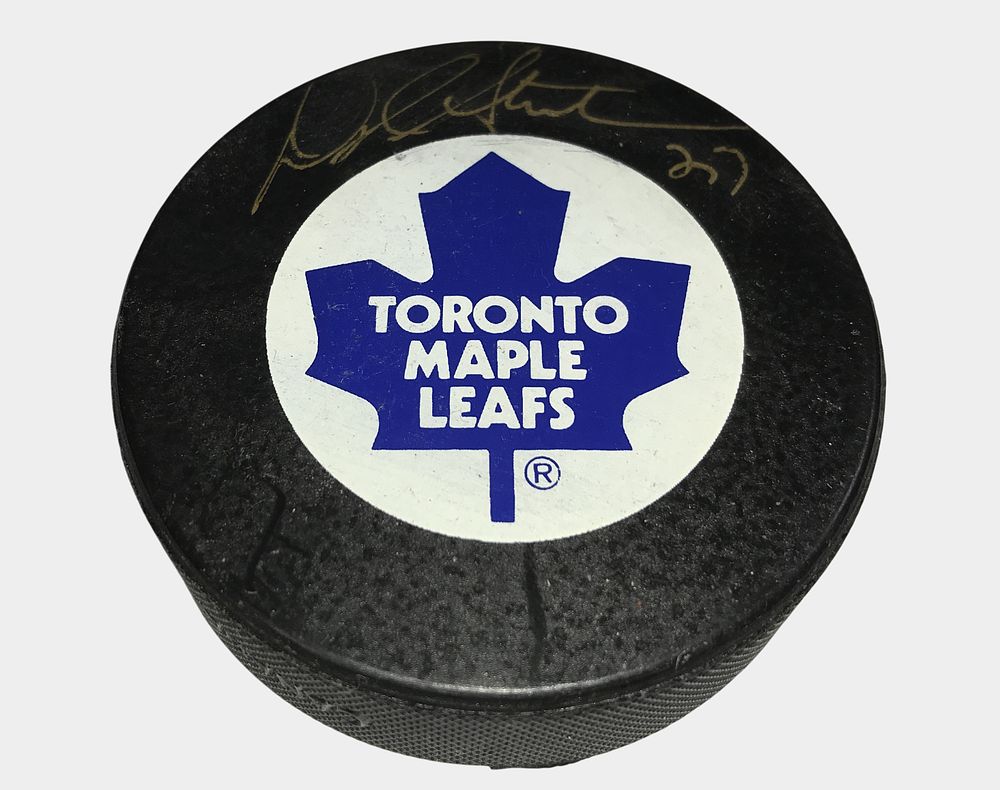 Lot 242b: A Collection of Four Autographed NHL Hockey Pucks Featuring Doug Gilmour, Teemu Selanne, Alexander Daigle, and Norm Ullman