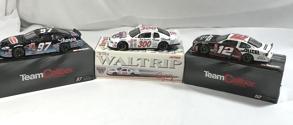 Lot 828: 3 diecast collectible race cars in org boxes
