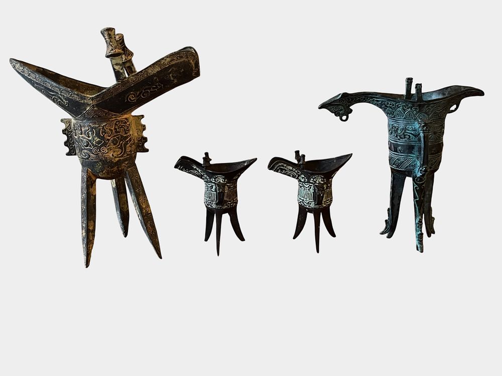 Lot 105: A Set of Four Chinese Archaic-Style Bronze Ritual Wine Vessels (Jue)