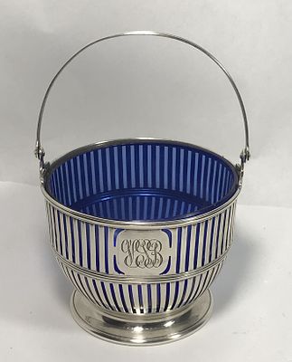 Sterling Swing Handle Sugar Basket. Sterling basket With cobalt blue glass liner, measures 2 1/2 