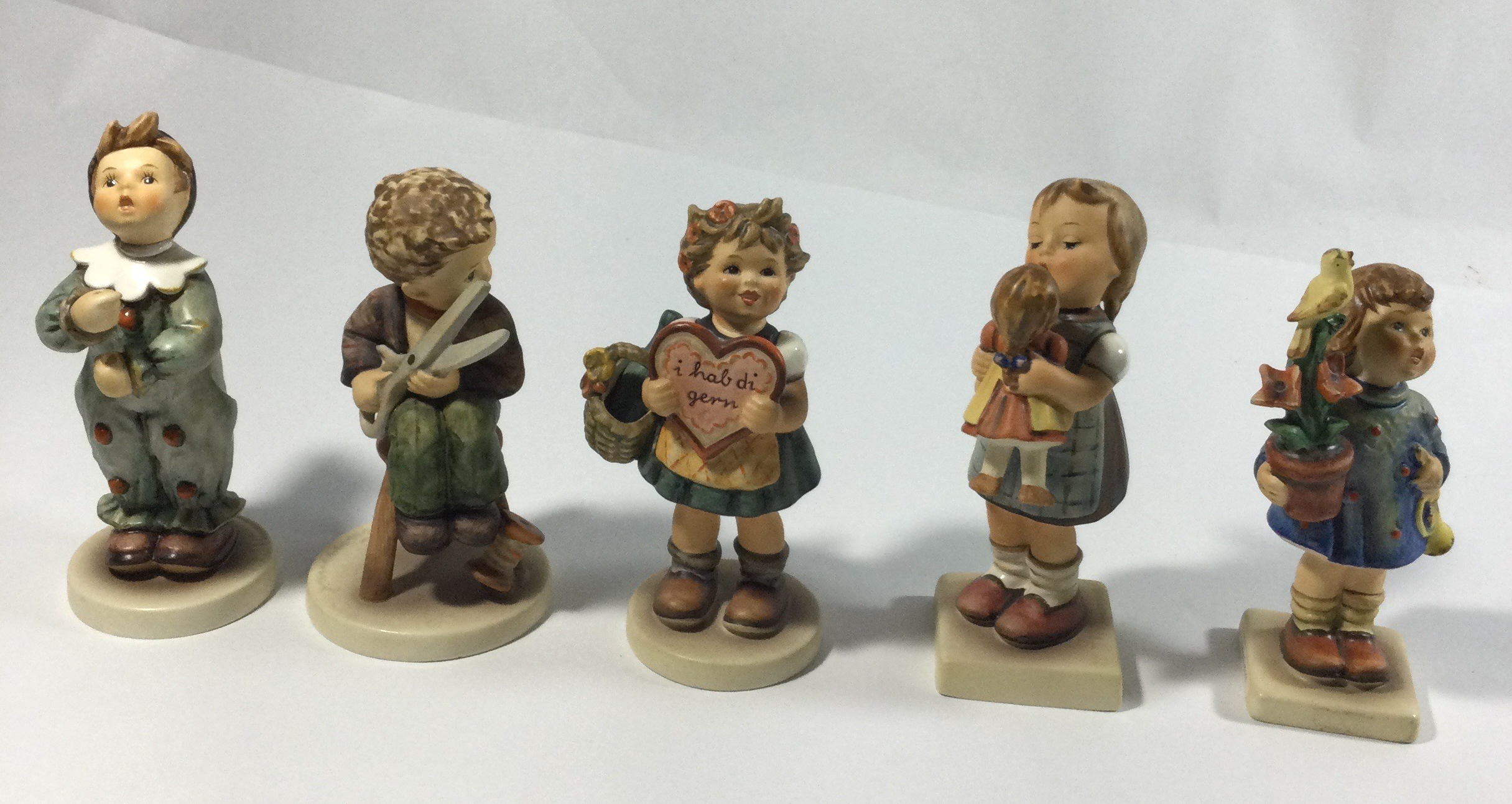 Five collectible Hummels figurines ,they are
