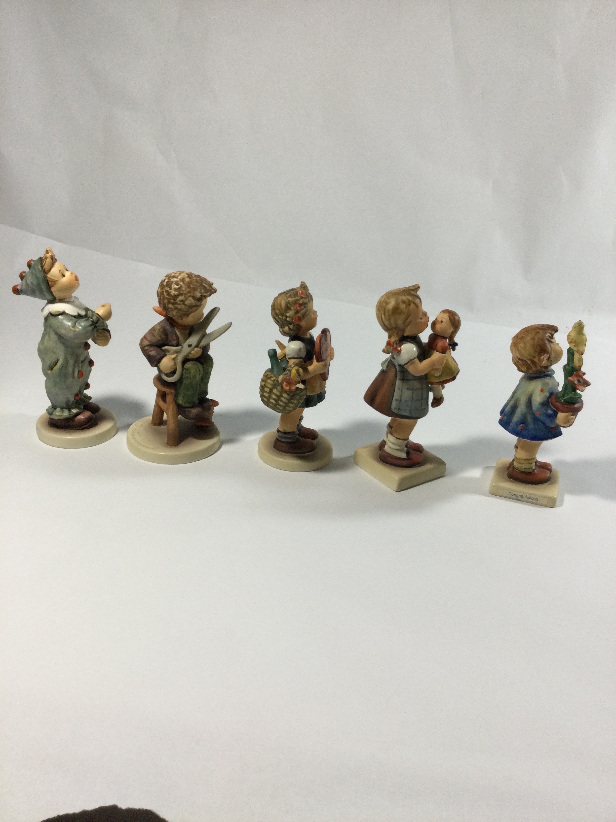 Five collectible Hummels figurines ,they are