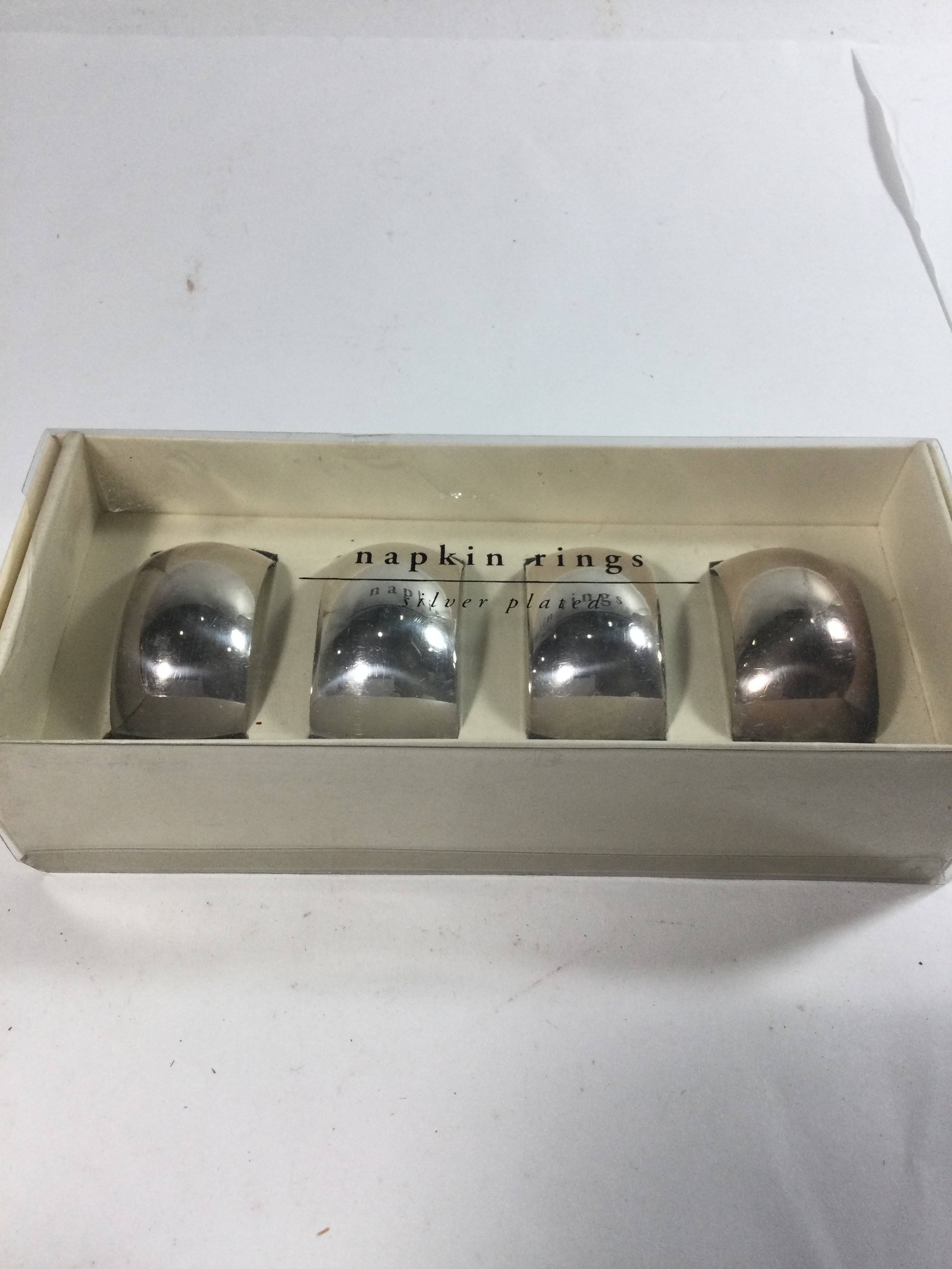 Four silver plated napkin rings