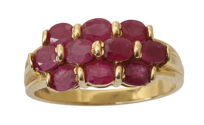 A 14K GOLD RING. Set with 3 rows of rubies. Size approx. 8 US. This ring can be enlarged and 