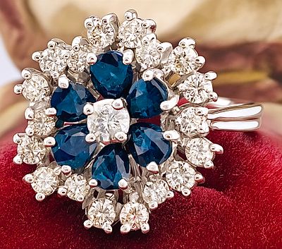18kt floral ring weighing 5.81 grams with 1.20 ct diamonds and sapphires. Vintage floral ring 