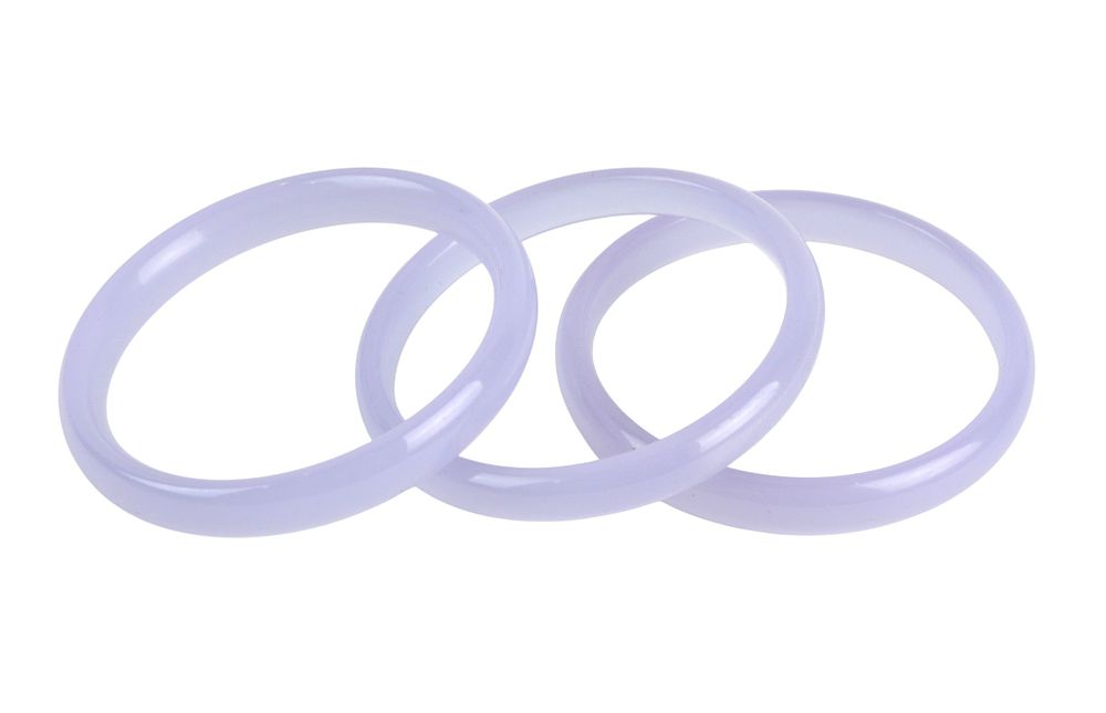Lot 184: Three Lavender Hardstone Bangle Bracelets