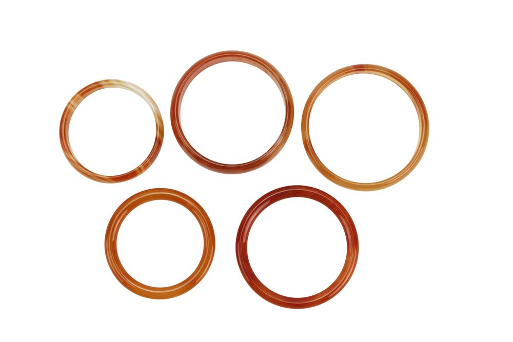 Lot 190: Five Assorted Hardstone Bangles