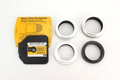 Vintage Photography Accessories Group. Group of vintage lens adapter rings and Kodak film disc 