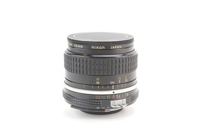 Nikon Nikkor 24mm f/2.8 Camera Lens. Vintage Nikon Nikkor 24mm f/2.8 manual-focus lens with cap. 